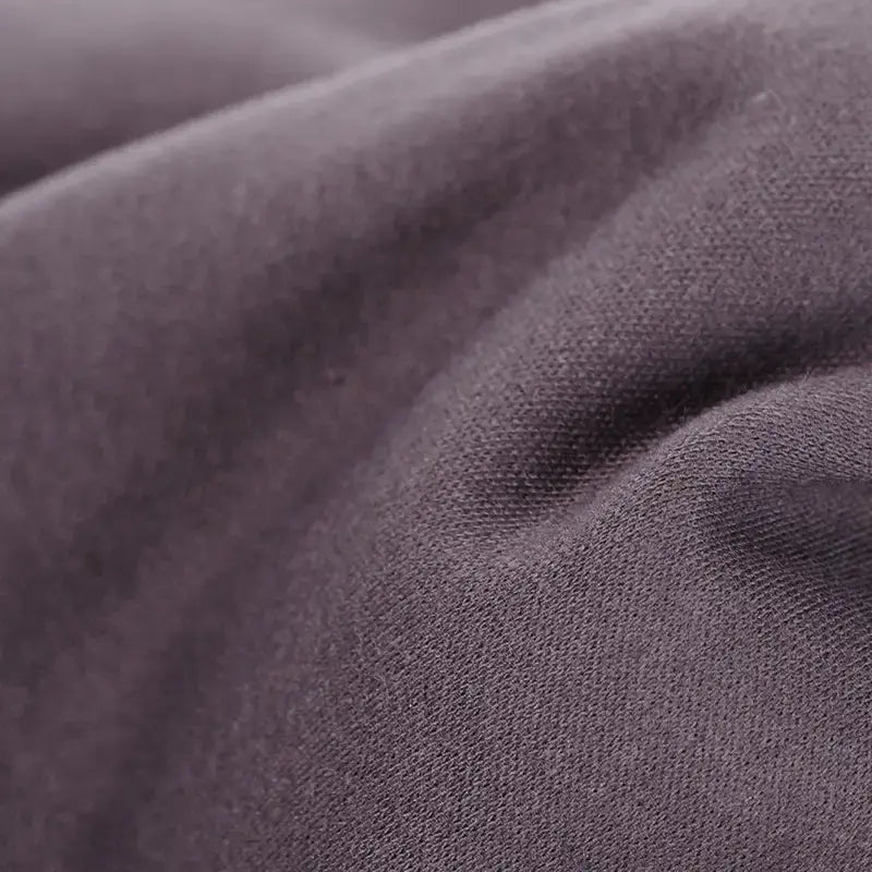 Close-up of textured dark brown organic cotton tricot dollmaking fabric
