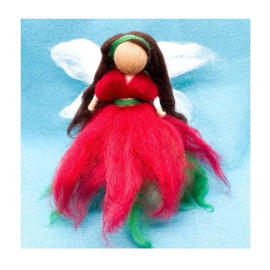Felted fairy figurine with red and green wool dress and white wings on a light blue background
