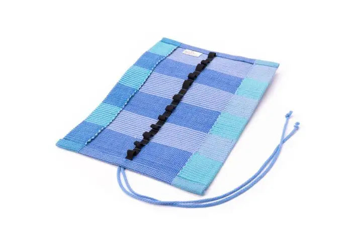 Three tone Blue crayon roll up case open to show pockets on white background
