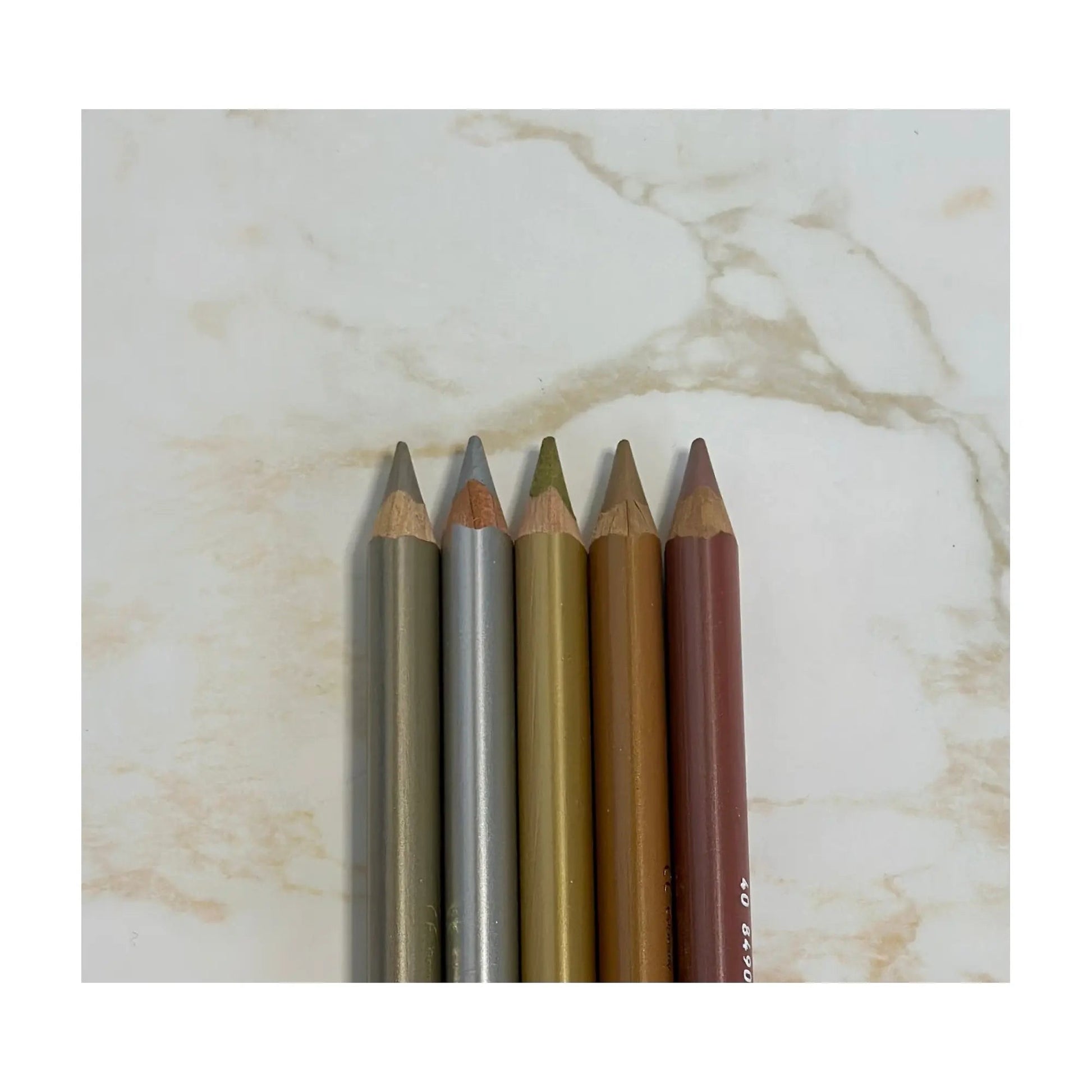 Set of makeup pencils on a marble surface