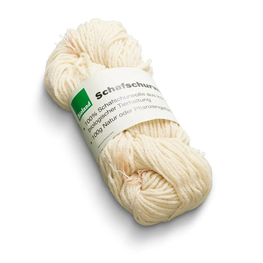 natural undyed organic wool yarn skein on a white background