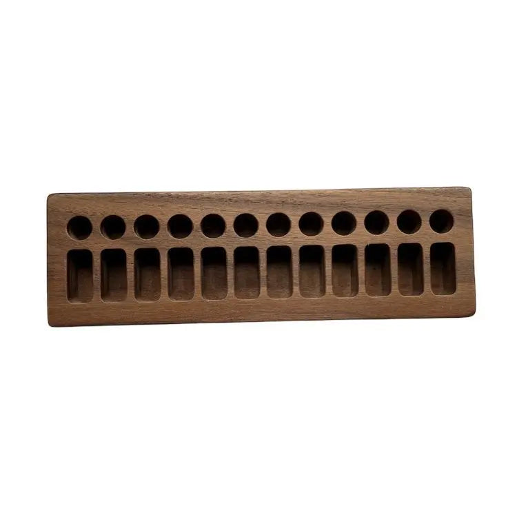 Wooden ice cube tray with multiple compartments on a white background