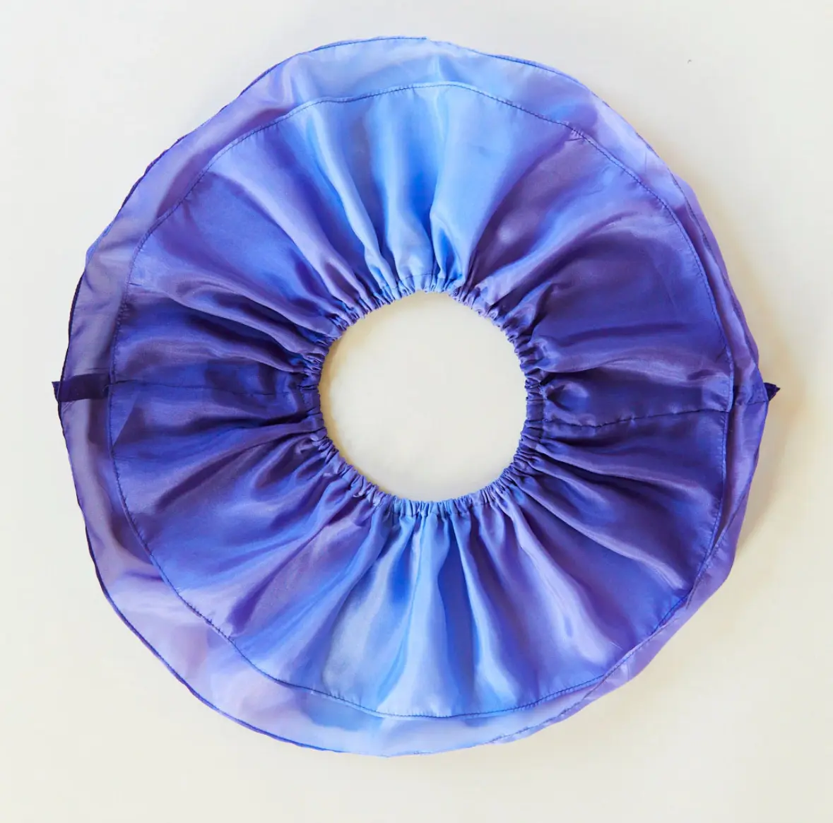 Sarah’s Silks Butterfly Tutu in purple seen from above, showcasing silk texture and stitching