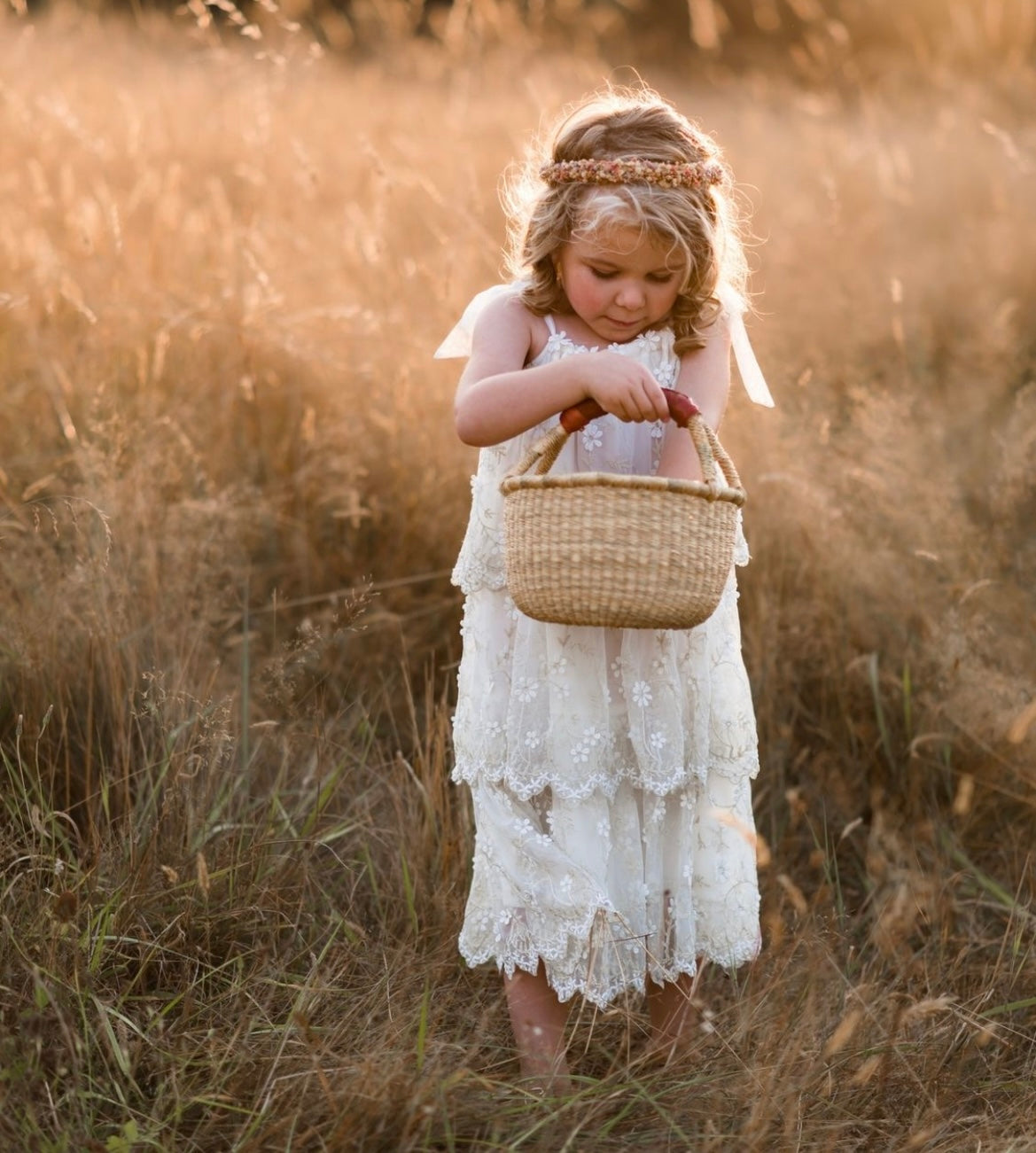 Baby Bolga Basket and a girl in a white dress - Alder & Alouette