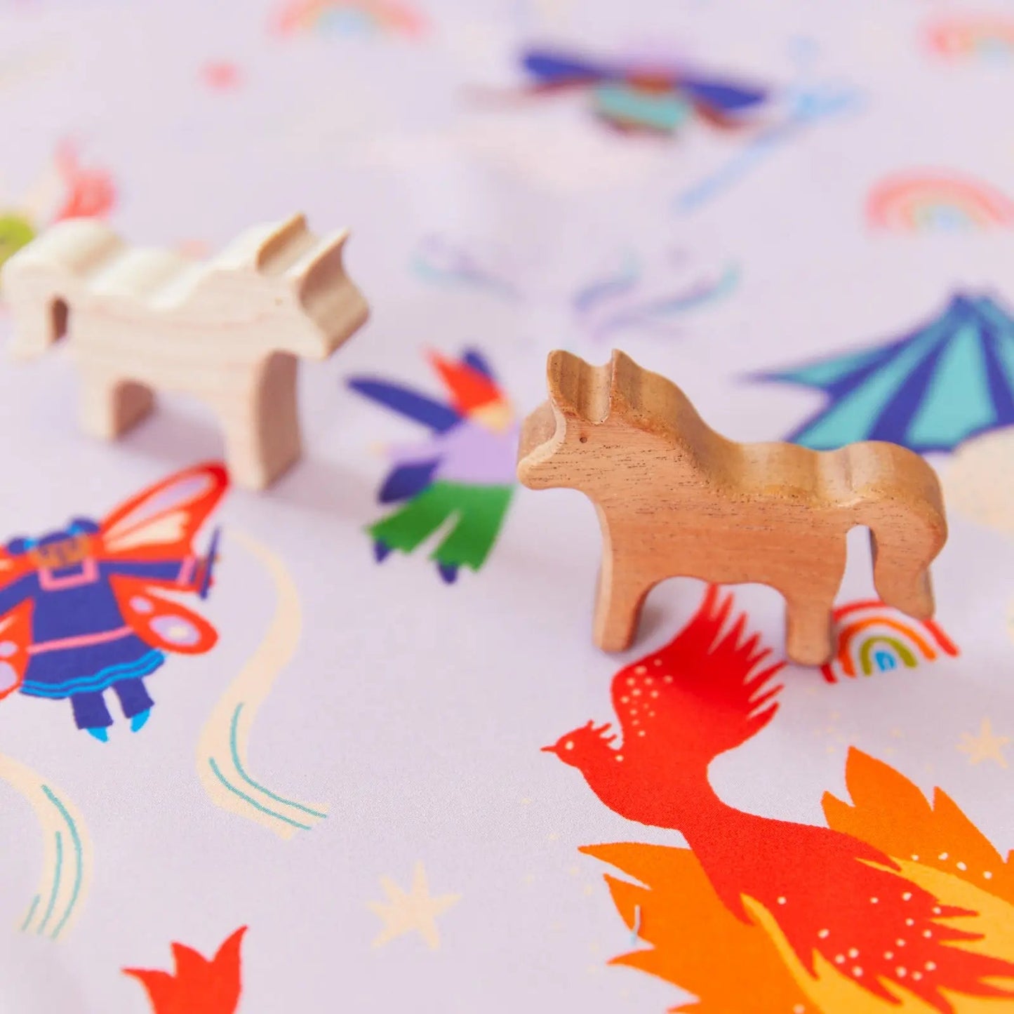 Magical Creatures Seek and Find Playsilk with a wooden unicorn toy on top