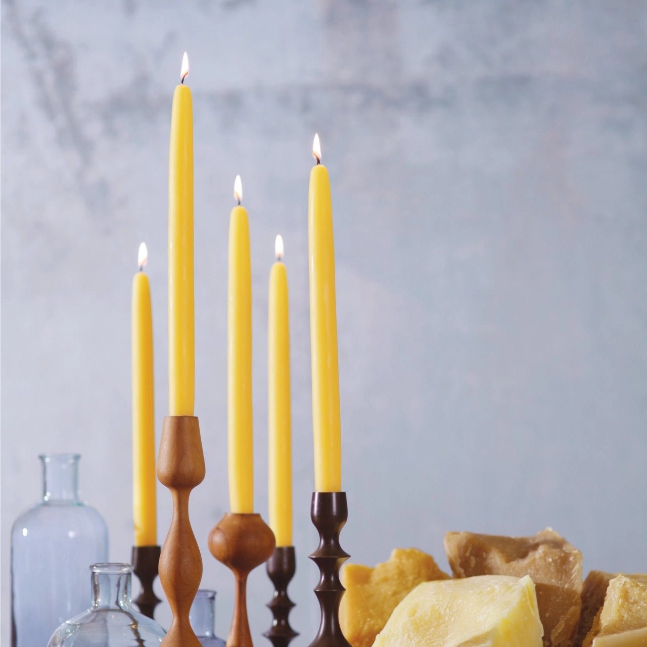 100% Beeswax Taper Candles on a Tabletop with Food