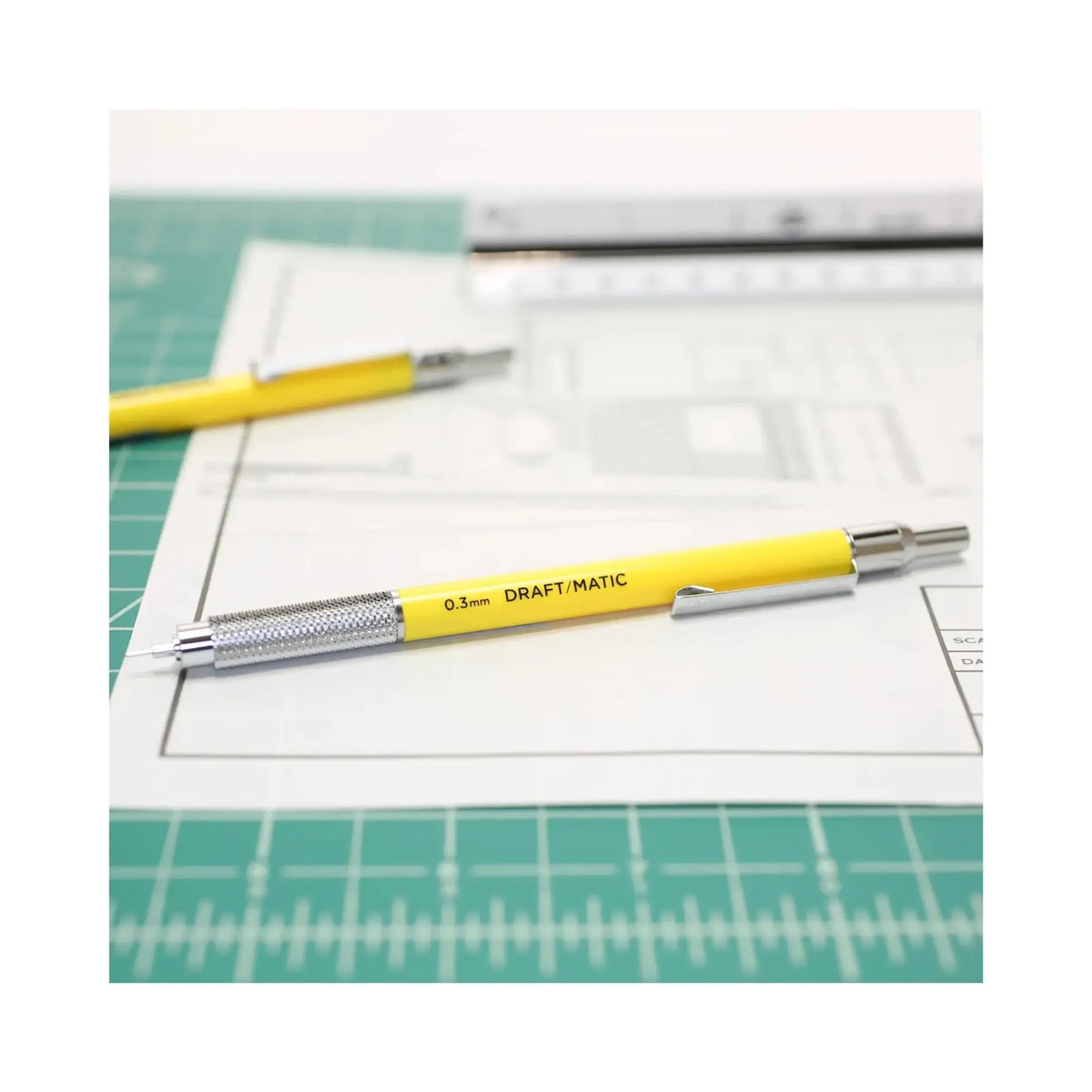 Yellow0.3mm Draft Matic Mechanical Pencil on top of blueprint plans