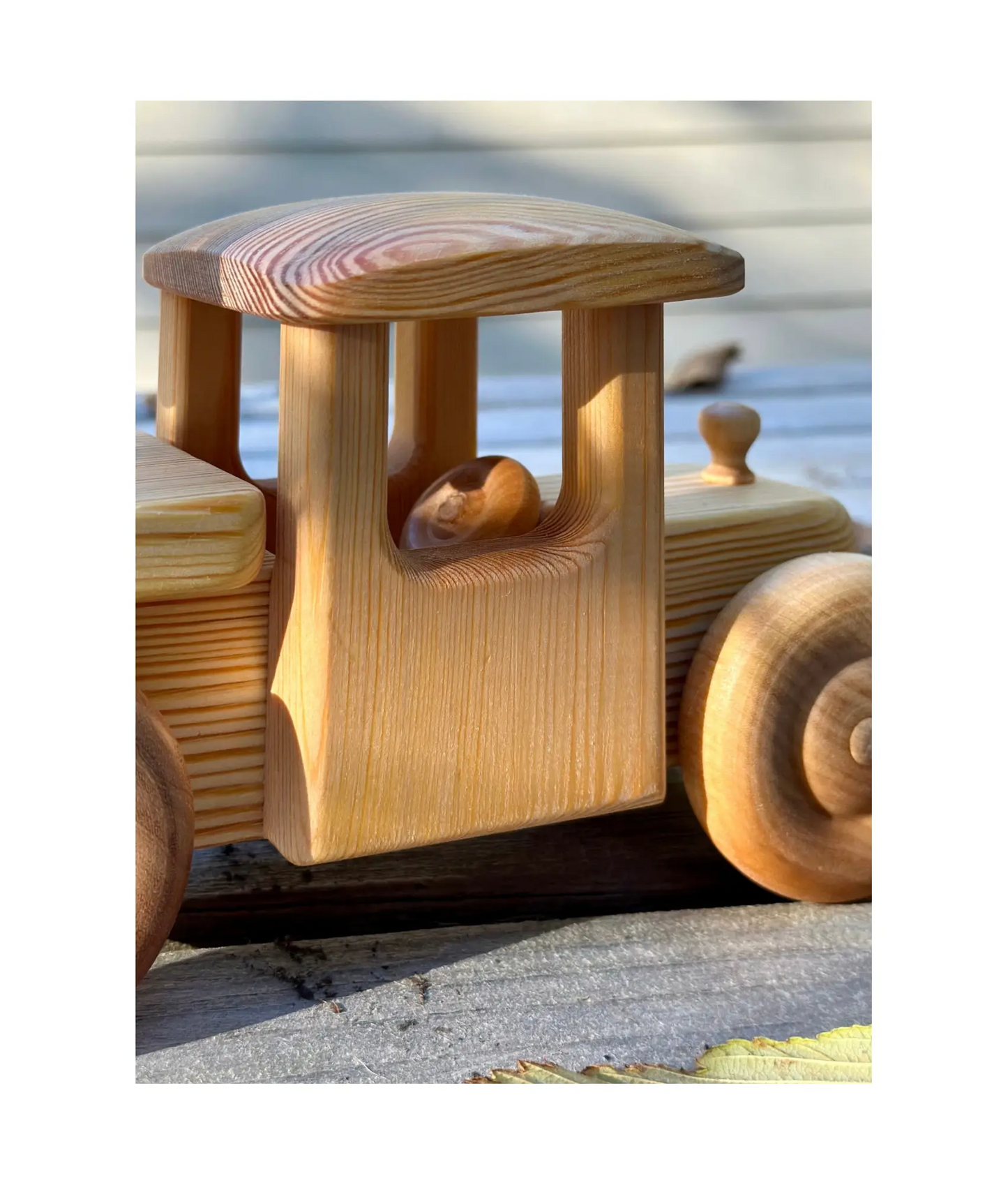 Wooden toy truck with a detailed design on a white background