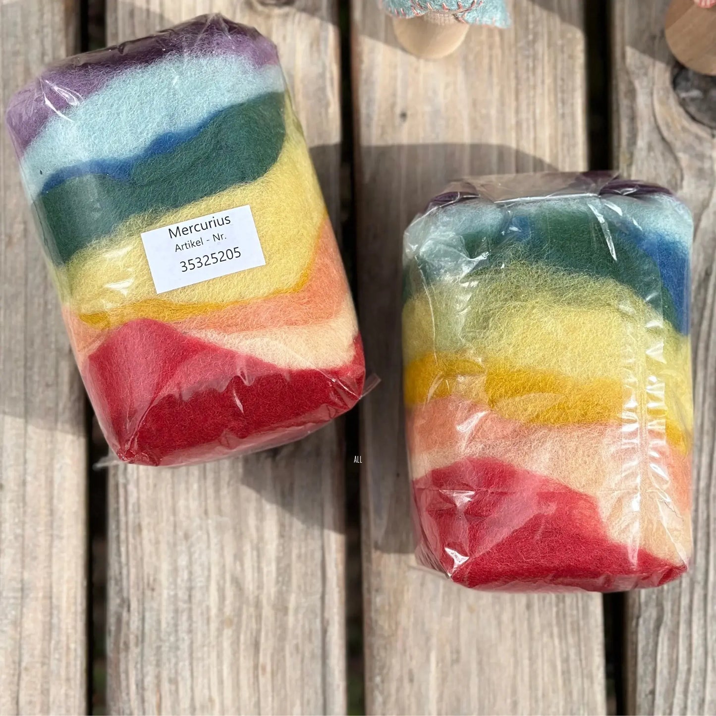 Two packages of colorful striped items on a wooden surface