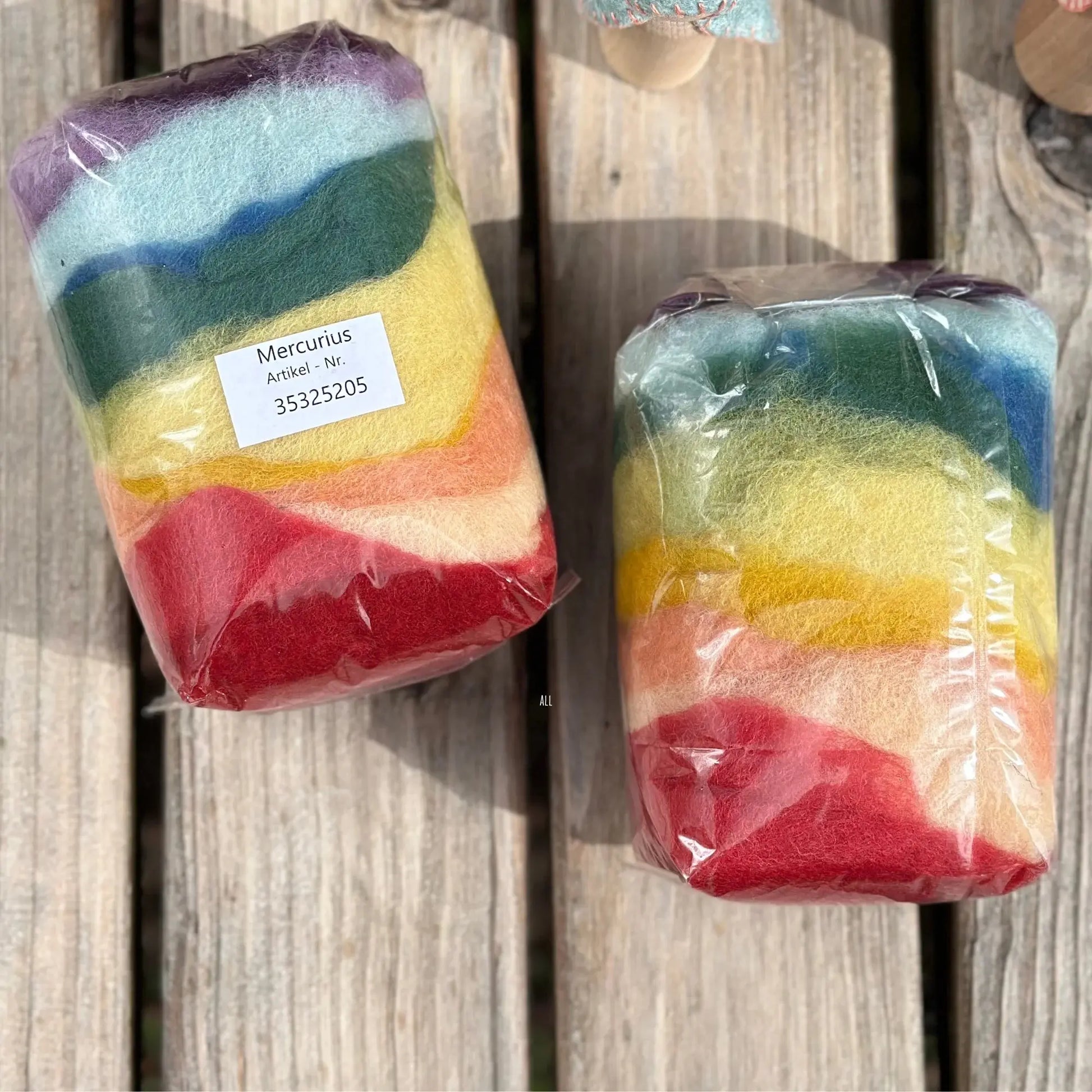 Two packages of colorful striped items on a wooden surface