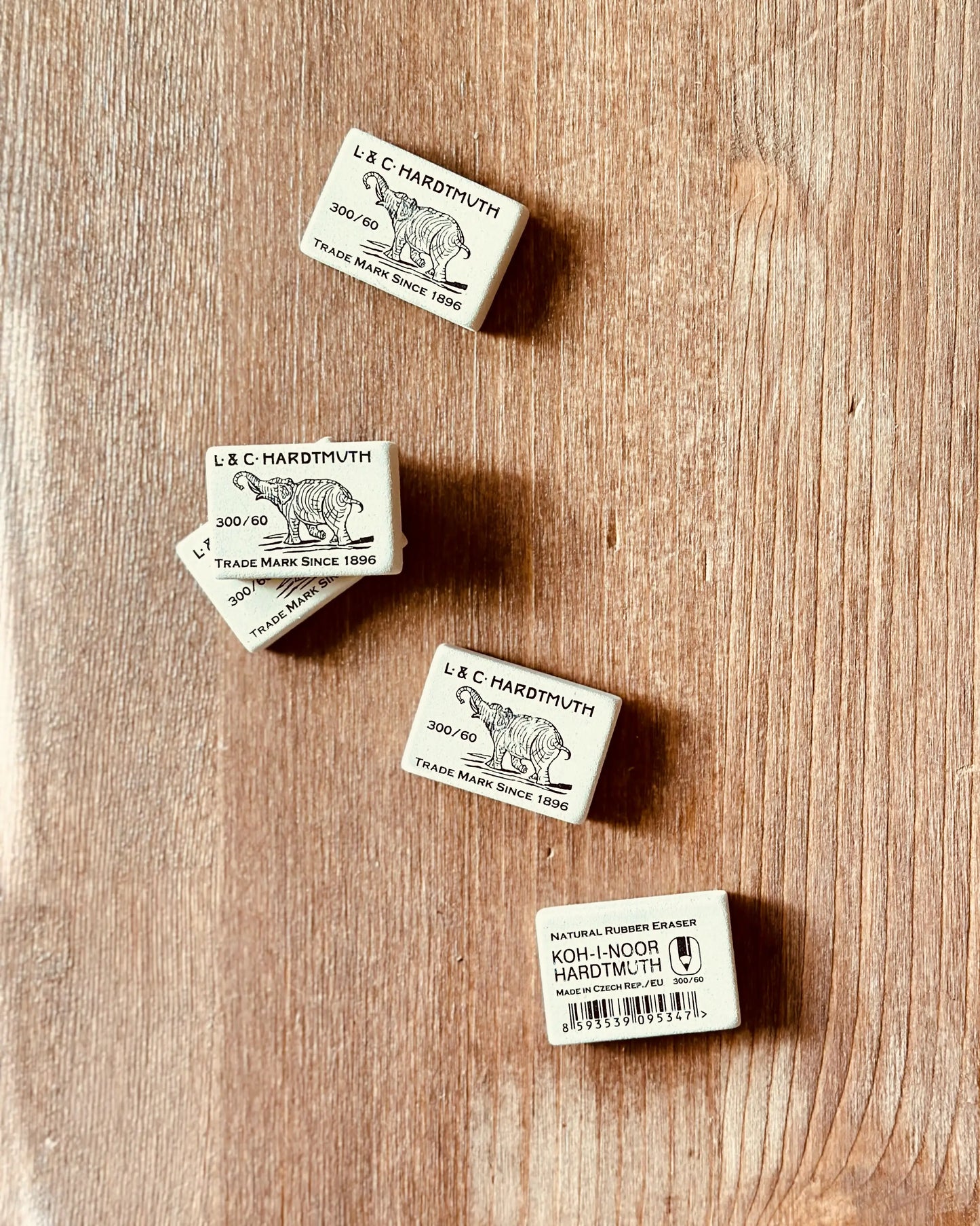 A scattering of Natural Rubber Erasers across a table top