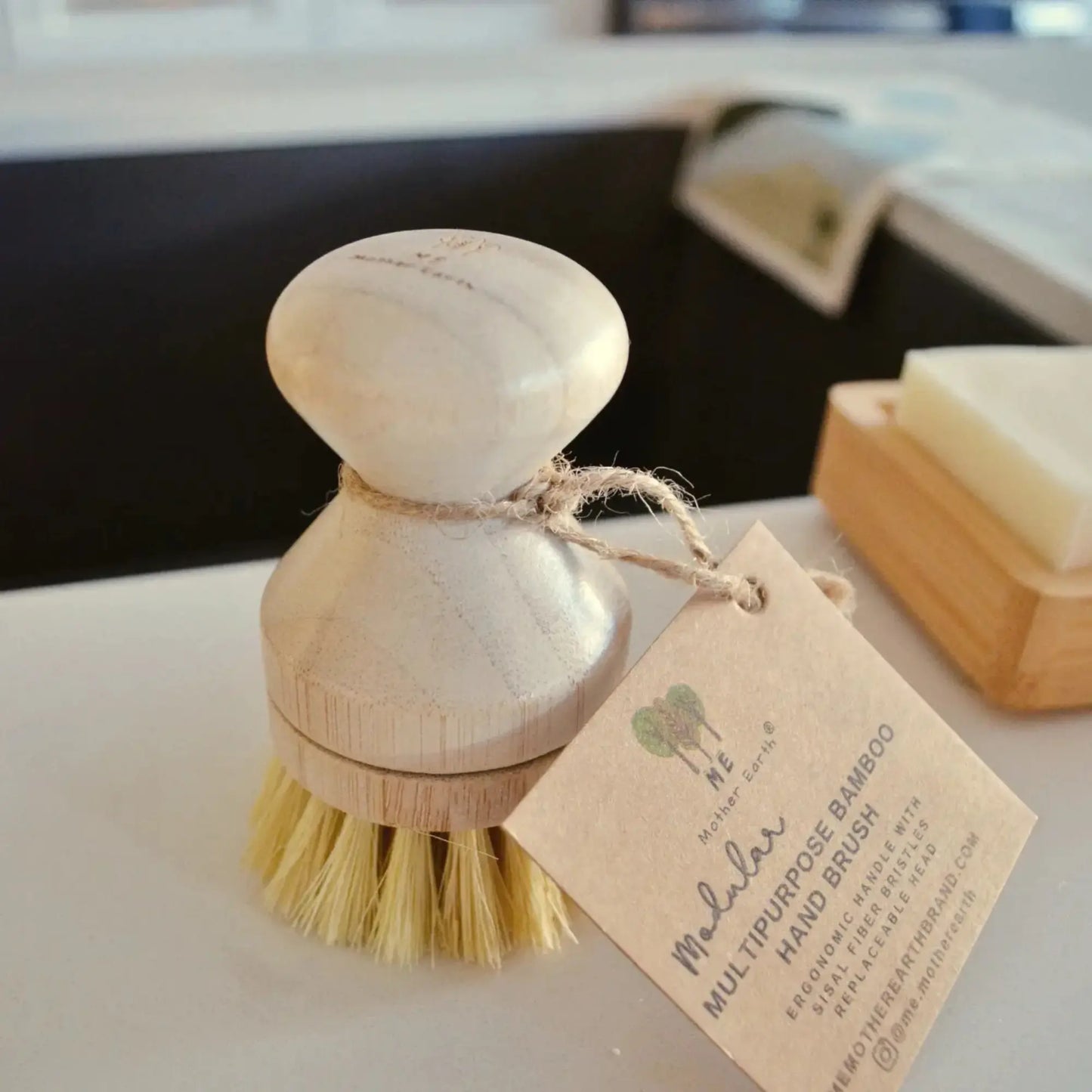 Wooden dish brush with a tag on a kitchen counter