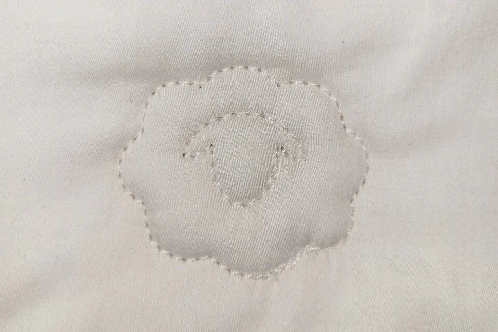 Close-up of a baby comforter quilting surface with concentric circular pattern