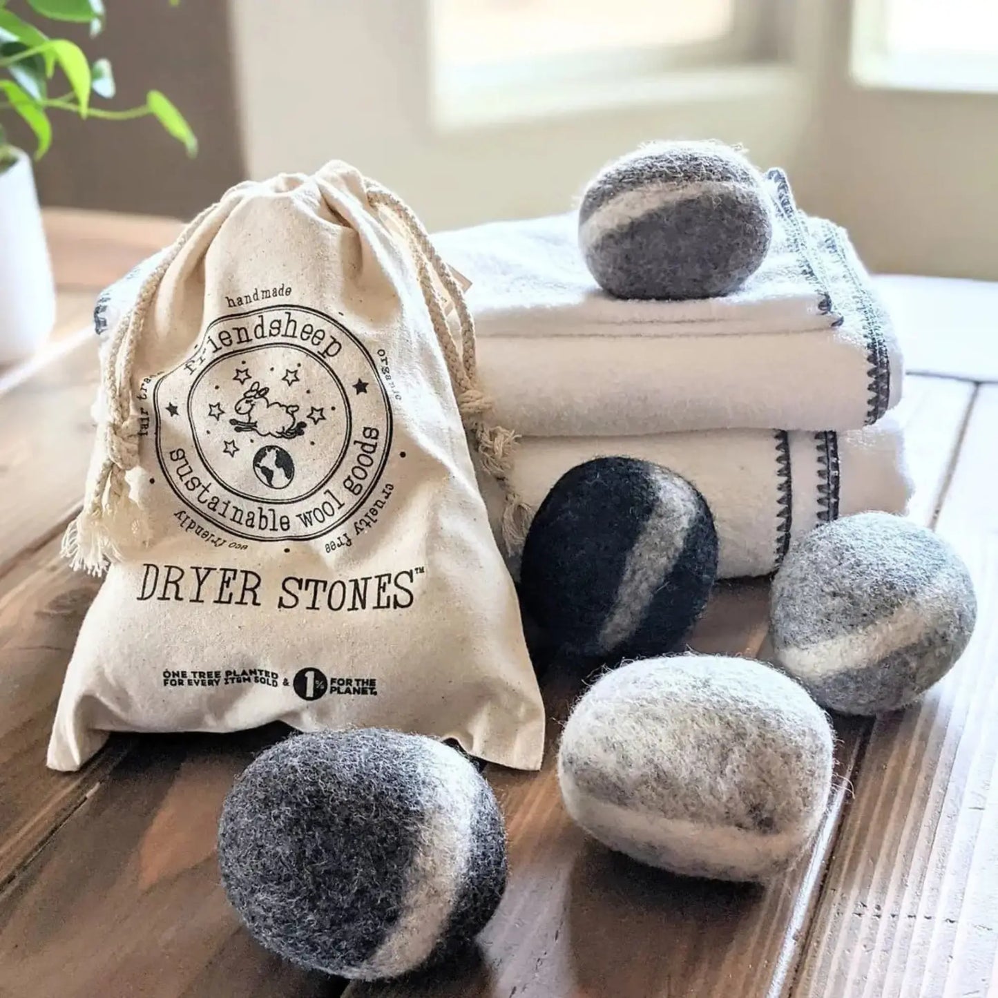 Dryer stones with a branded bag on a wooden surface