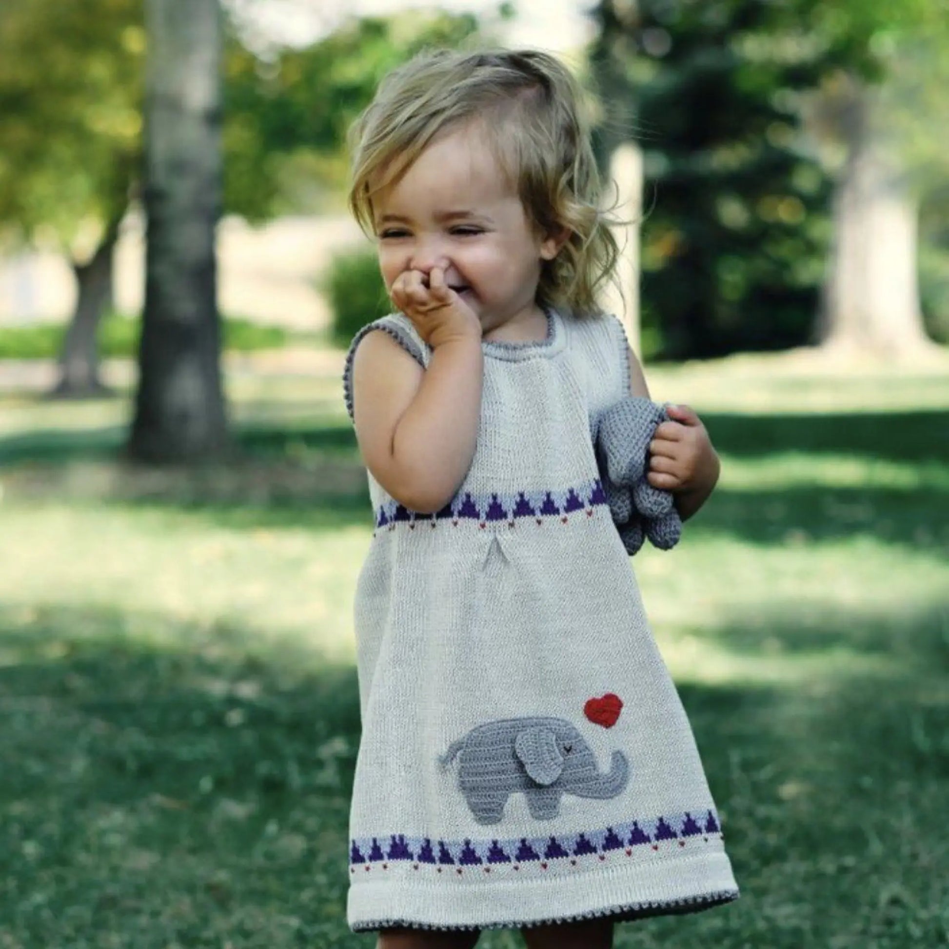 Toddler wearing Hand Knit Cotton Dress in Gray with blue and dark gray trim and red heart