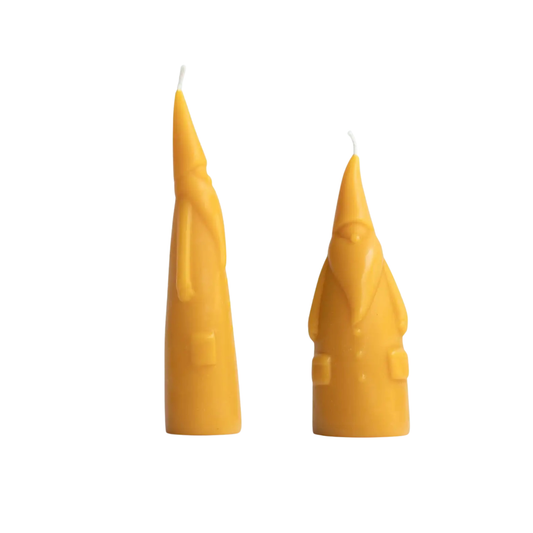 Two santa beeswax candles on a white background