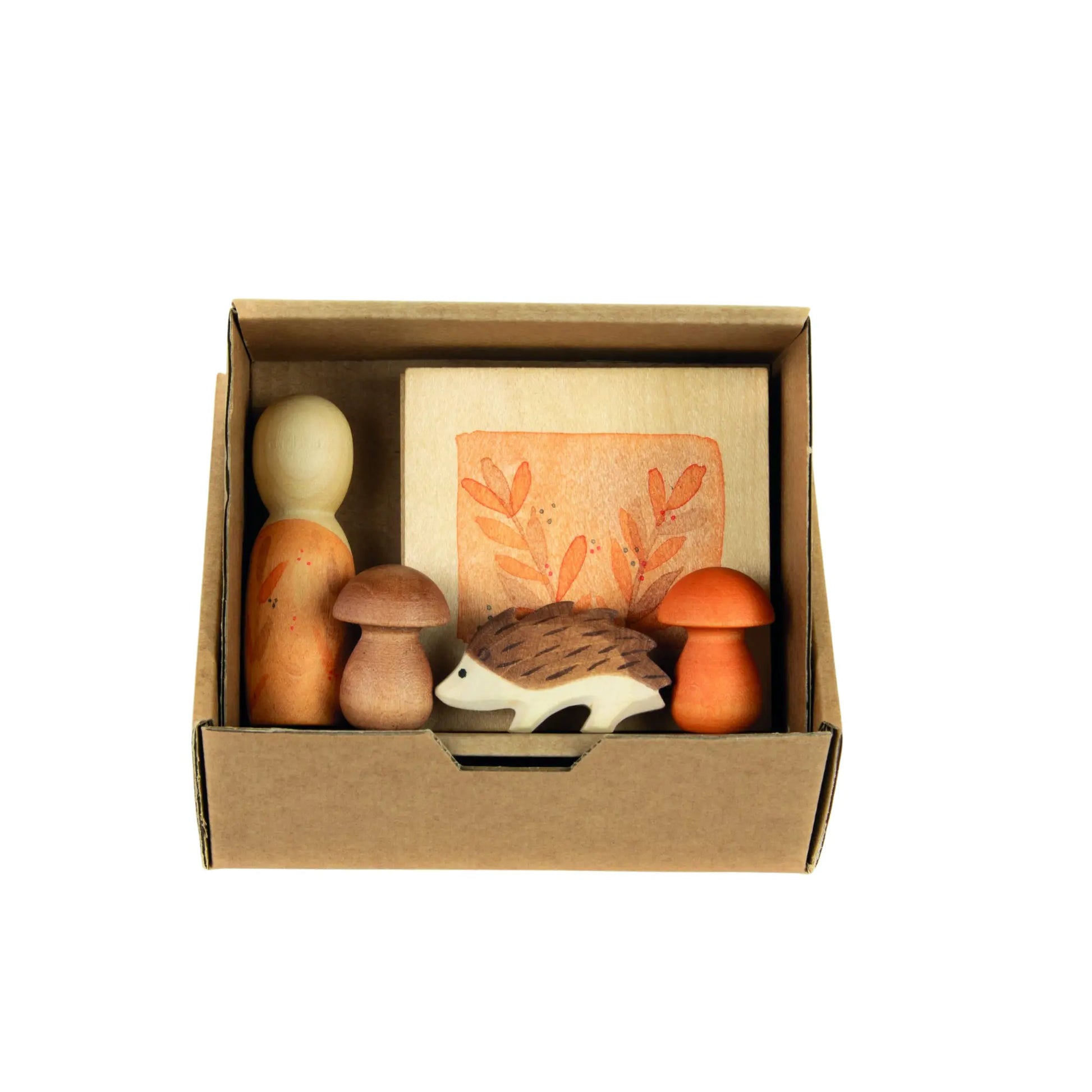 Set of Grapat and Ostheimer wooden toys including a hedgehog, mushrooms, and an egg in a cardboard box on a white background.