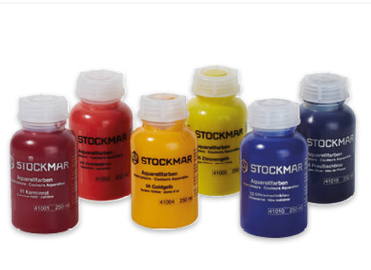 Set of Stockmar watercolor bottles in various colors on a white background