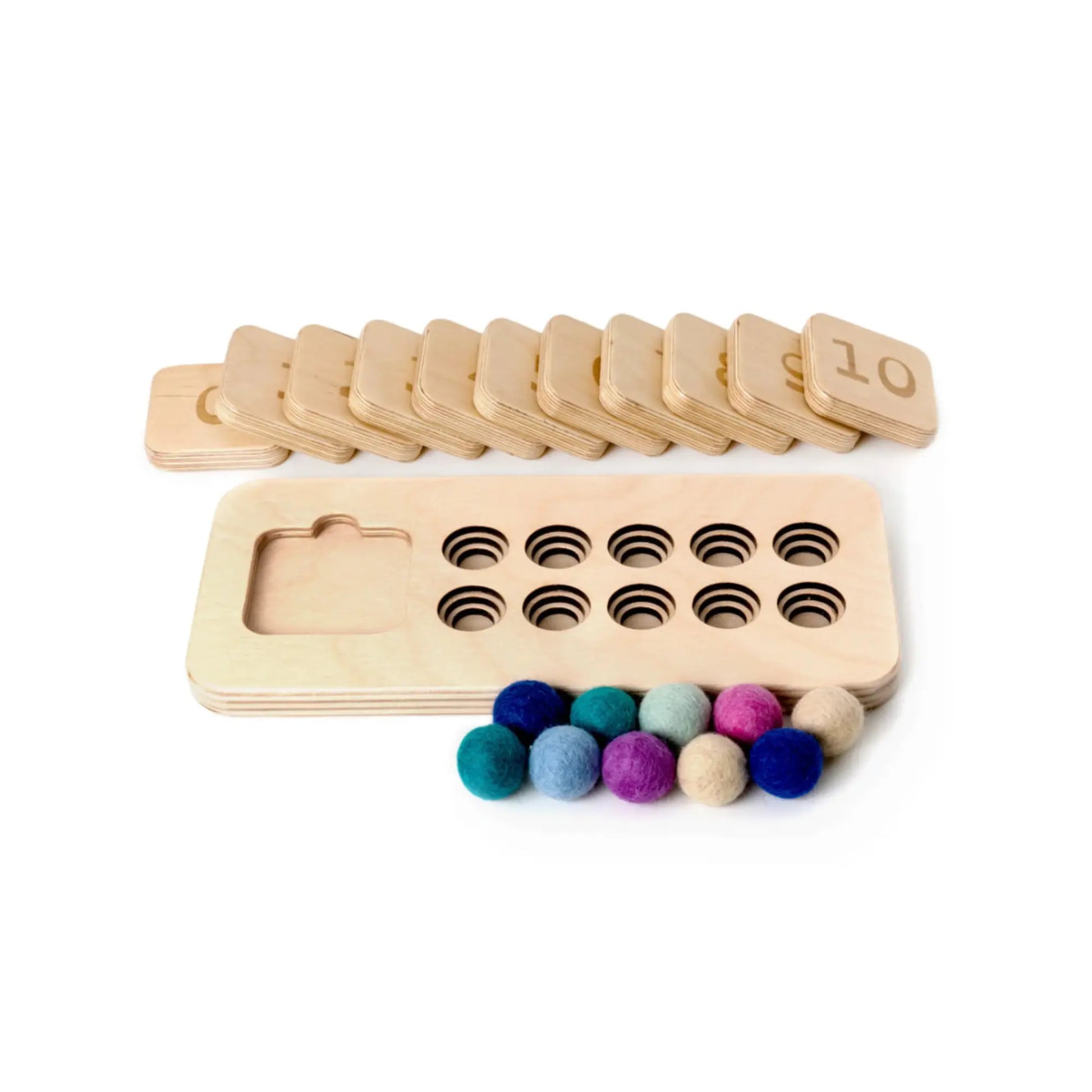 Close-up of wooden number tiles on Montessori-inspired quantity board for teaching counting and number recognition